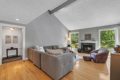 12 Oakvale Place Sw, Calgary, AB - Indoor Photo Showing Living Room With Fireplace