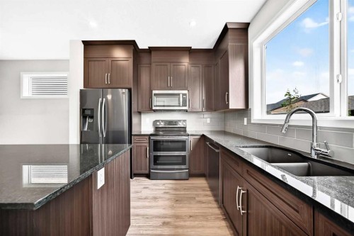 18 Willow Crescent, Okotoks, AB - Indoor Photo Showing Kitchen With Stainless Steel Kitchen With Double Sink With Upgraded Kitchen