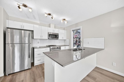 428 Cranbrook Square Se, Calgary, AB - Indoor Photo Showing Kitchen With Double Sink