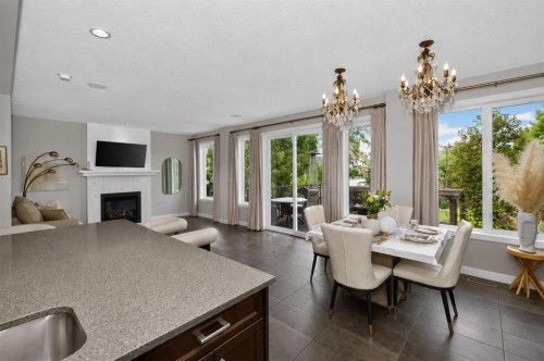 244 Mahogany Bay Se, Calgary, AB - Indoor Photo Showing Dining Room With Fireplace