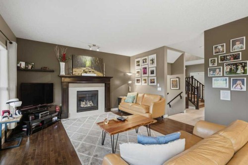 69 Everhollow Avenue Sw, Calgary, AB - Indoor Photo Showing Living Room With Fireplace