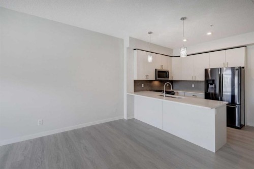 110-214 Sherwood Square Nw, Calgary, AB - Indoor Photo Showing Kitchen With Stainless Steel Kitchen