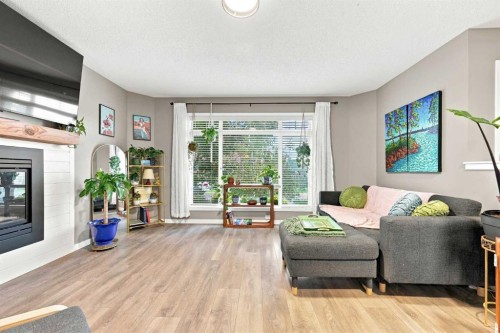 106 Autumn Crescent Se, Calgary, AB - Indoor Photo Showing Living Room With Fireplace
