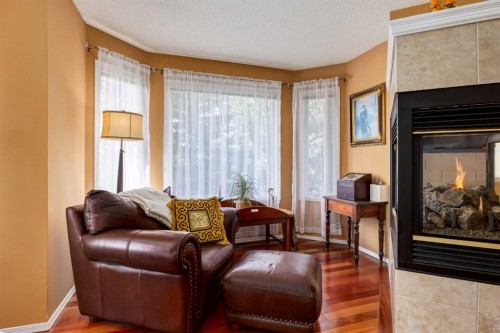 142 Springbank Crescent Sw, Calgary, AB - Indoor Photo Showing Living Room With Fireplace