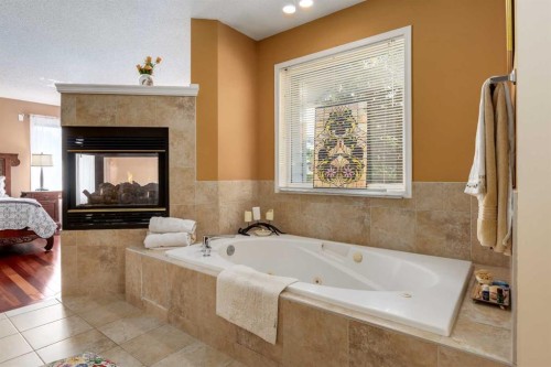 142 Springbank Crescent Sw, Calgary, AB - Indoor Photo Showing Bathroom With Fireplace