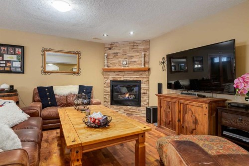 142 Springbank Crescent Sw, Calgary, AB - Indoor Photo Showing Living Room With Fireplace