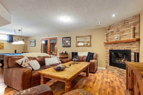 142 Springbank Crescent Sw, Calgary, AB - Indoor Photo Showing Living Room With Fireplace