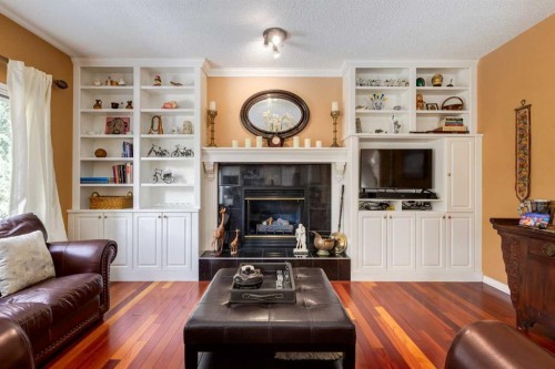 142 Springbank Crescent Sw, Calgary, AB - Indoor Photo Showing Living Room With Fireplace