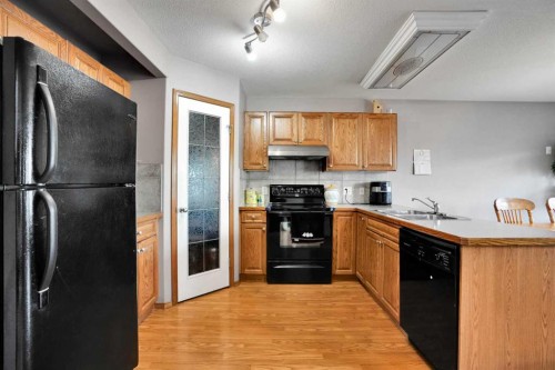 49 Saddletree Close Ne, Calgary, AB - Indoor Photo Showing Kitchen With Double Sink