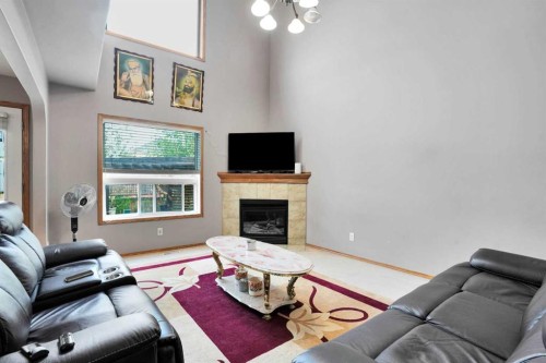 49 Saddletree Close Ne, Calgary, AB - Indoor Photo Showing Living Room With Fireplace