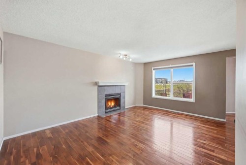 86 Saddlecrest Close Ne, Calgary, AB - Indoor Photo Showing Living Room With Fireplace