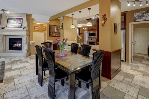 66 Copperfield Close Se, Calgary, AB - Indoor Photo Showing Dining Room With Fireplace