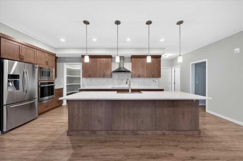 406-4350 Seton Drive Se, Calgary, AB - Indoor Photo Showing Kitchen With Stainless Steel Kitchen With Upgraded Kitchen