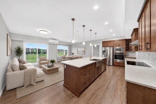 406-4350 Seton Drive Se, Calgary, AB - Indoor Photo Showing Kitchen With Stainless Steel Kitchen With Upgraded Kitchen