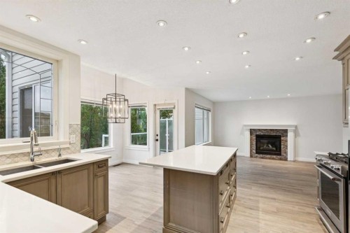 38 Tuscany Hills Crescent Nw, Calgary, AB - Indoor Photo Showing Kitchen With Fireplace With Double Sink