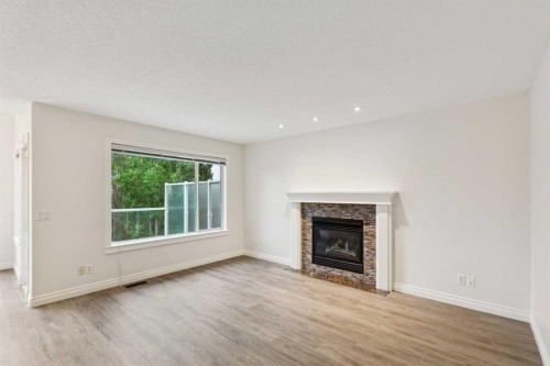 38 Tuscany Hills Crescent Nw, Calgary, AB - Indoor Photo Showing Living Room With Fireplace