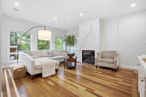 109 Shawnee Place Sw, Calgary, AB - Indoor Photo Showing Living Room With Fireplace