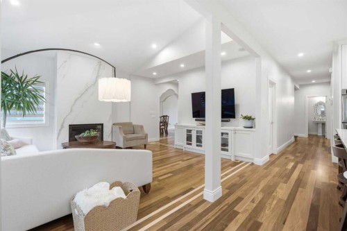109 Shawnee Place Sw, Calgary, AB - Indoor Photo Showing Other Room With Fireplace
