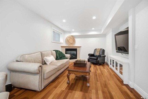 109 Shawnee Place Sw, Calgary, AB - Indoor Photo Showing Living Room With Fireplace