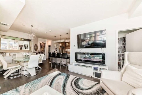 202-122 Mahogany Centre Se, Calgary, AB - Indoor Photo Showing Living Room With Fireplace
