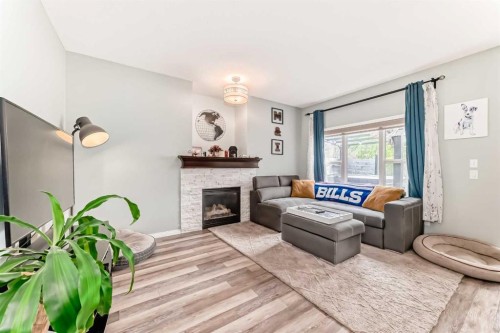 485 Cimarron Boulevard, Okotoks, AB - Indoor Photo Showing Living Room With Fireplace