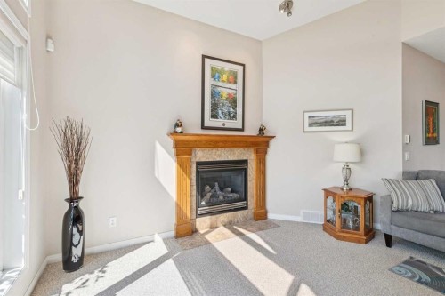7 Wentworth Landing Sw, Calgary, AB - Indoor Photo Showing Living Room With Fireplace