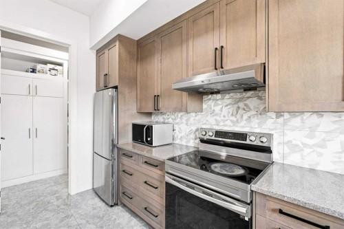 201 Milton Road, Conrich, AB - Indoor Photo Showing Kitchen With Stainless Steel Kitchen