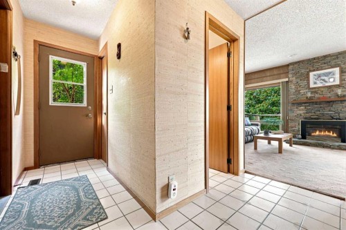 1148 Edgemont Road Nw, Calgary, AB - Indoor Photo Showing Other Room With Fireplace