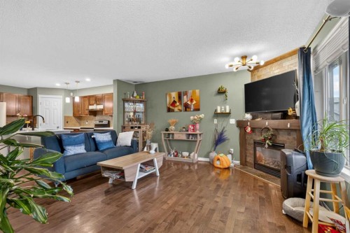 66 Panatella Park Nw, Calgary, AB - Indoor Photo Showing Living Room With Fireplace