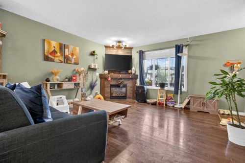 66 Panatella Park Nw, Calgary, AB - Indoor Photo Showing Living Room With Fireplace