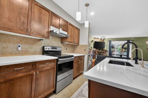 66 Panatella Park Nw, Calgary, AB - Indoor Photo Showing Kitchen With Double Sink