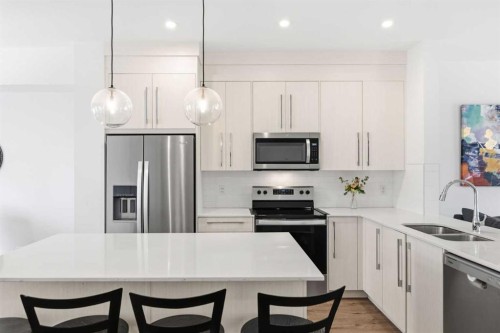 602-335 Creekside Boulevard Sw, Calgary, AB - Indoor Photo Showing Kitchen With Stainless Steel Kitchen With Double Sink With Upgraded Kitchen