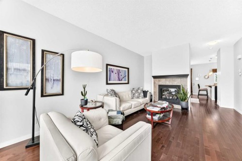 302 Sunset Point, Cochrane, AB - Indoor Photo Showing Living Room With Fireplace