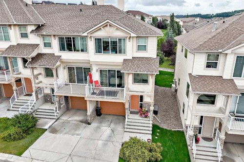 302 Sunset Point, Cochrane, AB - Outdoor With Deck Patio Veranda With Facade