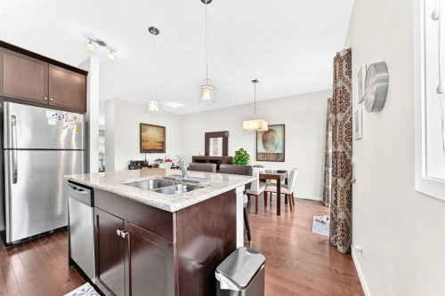 302 Sunset Point, Cochrane, AB - Indoor Photo Showing Kitchen With Stainless Steel Kitchen With Double Sink With Upgraded Kitchen
