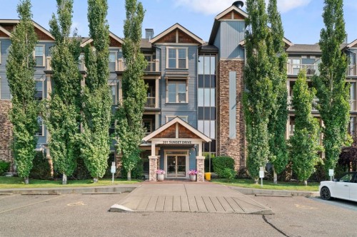 407-201 Sunset Drive, Cochrane, AB - Outdoor With Facade