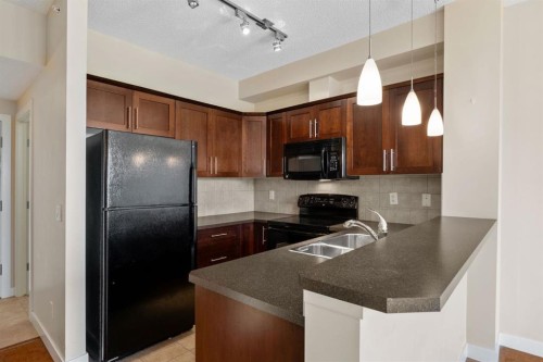 407-201 Sunset Drive, Cochrane, AB - Indoor Photo Showing Kitchen With Double Sink