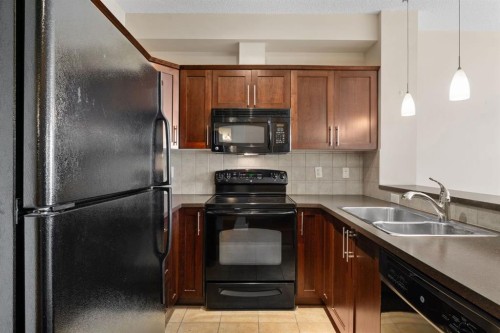 407-201 Sunset Drive, Cochrane, AB - Indoor Photo Showing Kitchen With Double Sink