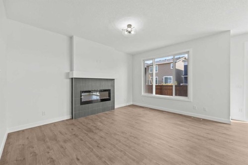 37 Sora Gardens Se, Calgary, AB - Indoor Photo Showing Living Room With Fireplace