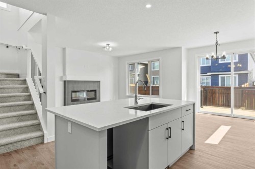 37 Sora Gardens Se, Calgary, AB - Indoor Photo Showing Kitchen With Fireplace