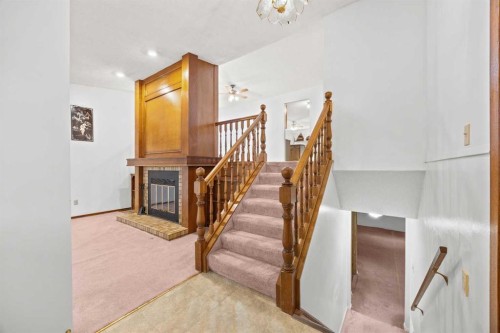147 Whitlock Close Ne, Calgary, AB - Indoor Photo Showing Other Room With Fireplace