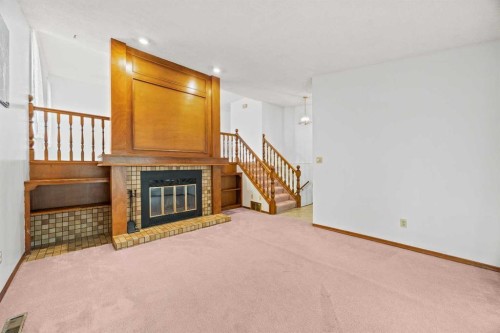 147 Whitlock Close Ne, Calgary, AB - Indoor Photo Showing Other Room With Fireplace