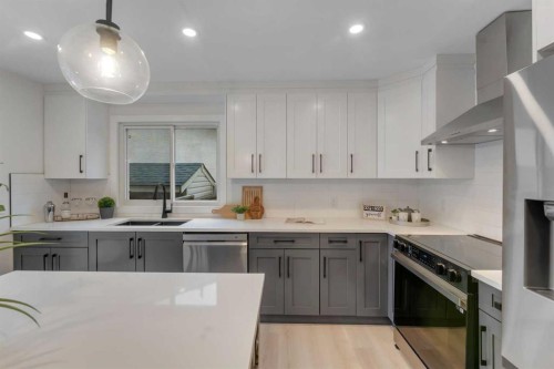 104 Oakmoor Place Sw, Calgary, AB - Indoor Photo Showing Kitchen With Stainless Steel Kitchen With Double Sink With Upgraded Kitchen