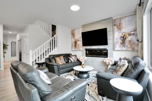 159 Hotchkiss Manor Se, Calgary, AB - Indoor Photo Showing Living Room With Fireplace