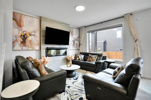 159 Hotchkiss Manor Se, Calgary, AB - Indoor Photo Showing Living Room With Fireplace