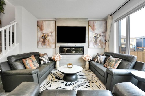 159 Hotchkiss Manor Se, Calgary, AB - Indoor Photo Showing Living Room With Fireplace