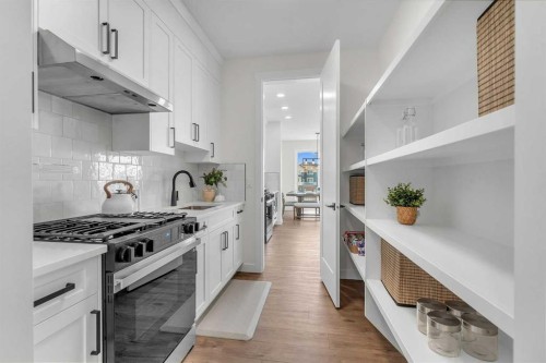 319 Kinniburgh Loop, Chestermere, AB - Indoor Photo Showing Kitchen With Upgraded Kitchen