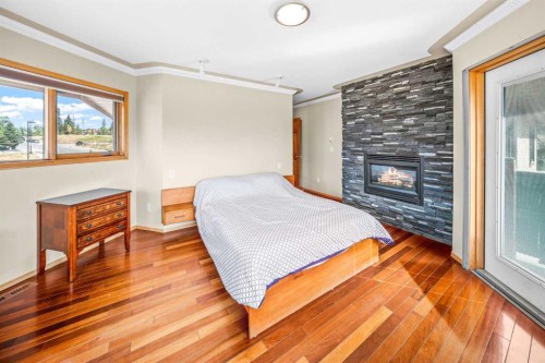 1 Eagle Landing, Canmore, AB - Indoor Photo Showing Bedroom With Fireplace