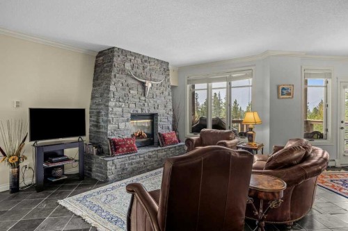 202-140 Stonecreek Road, Canmore, AB - Indoor Photo Showing Living Room With Fireplace