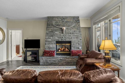 202-140 Stonecreek Road, Canmore, AB - Indoor Photo Showing Living Room With Fireplace